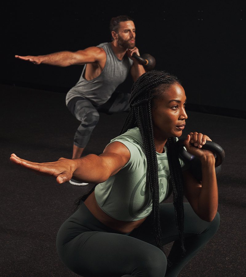a man and a woman doing group workout